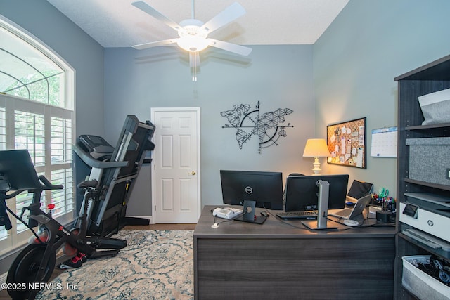 office space with baseboards, a ceiling fan, and wood finished floors