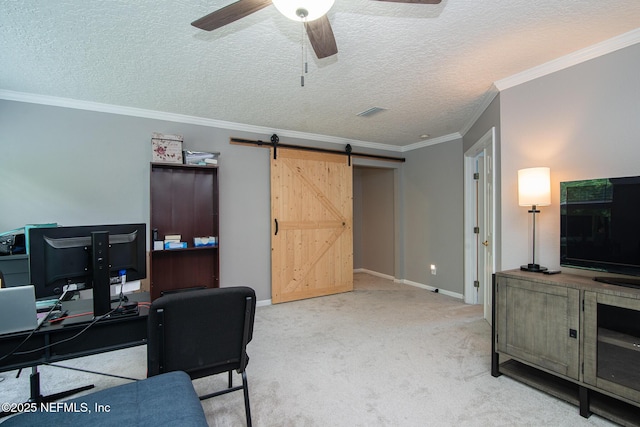 carpeted office featuring crown molding, ceiling fan, a barn door, a textured ceiling, and baseboards