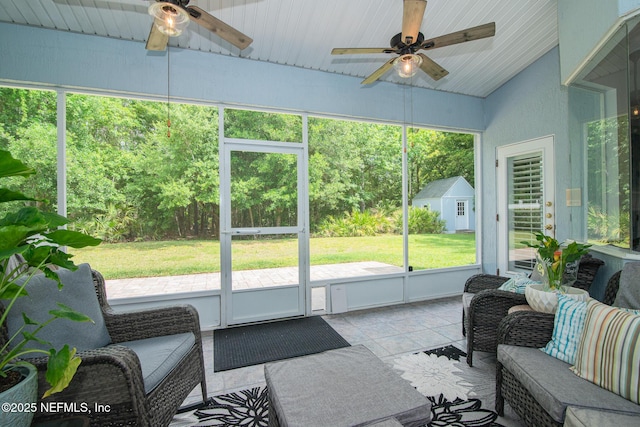 sunroom / solarium with ceiling fan and an outdoor living space