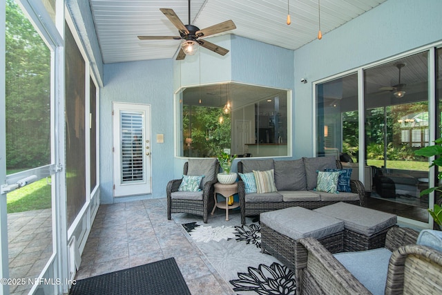 sunroom featuring an outdoor living space and a ceiling fan