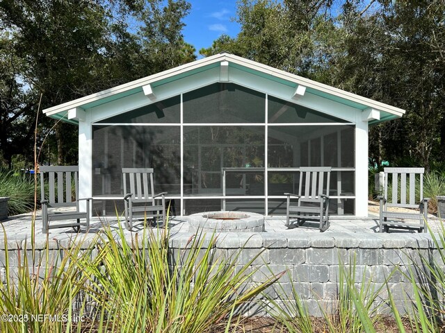655 Juniper Hills Dr, Saint Johns, FL 32259 - rear view of property with a sunroom and a fire pit