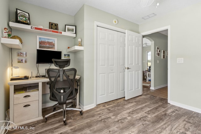 office area with baseboards and wood finished floors
