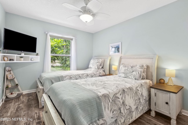 bedroom with a ceiling fan, baseboards, and wood finished floors