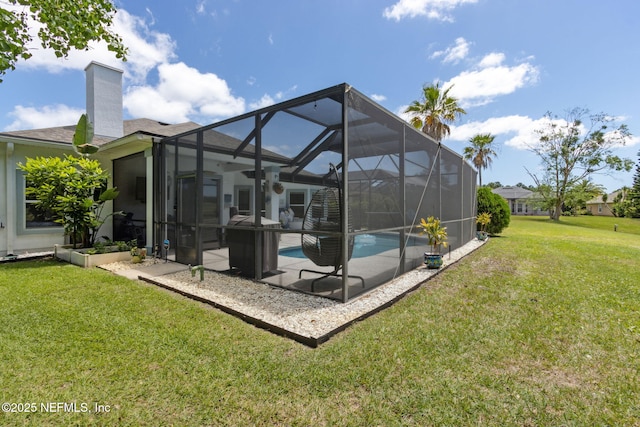 back of property featuring an outdoor pool, a chimney, a patio area, a lanai, and a yard