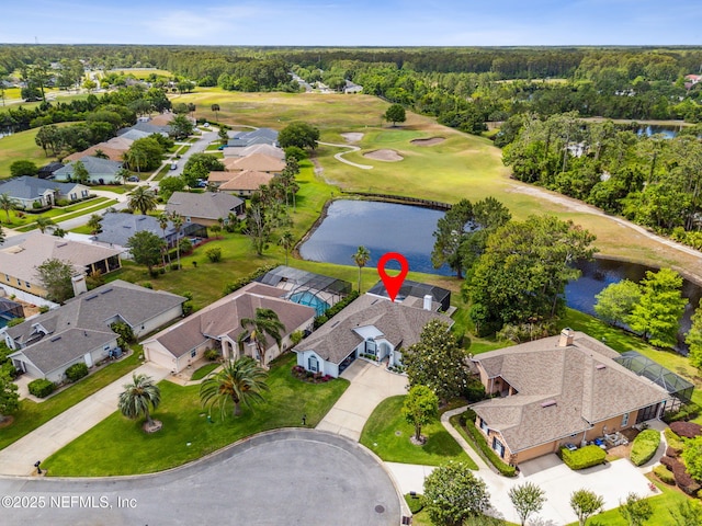 drone / aerial view featuring a residential view, view of golf course, and a water view