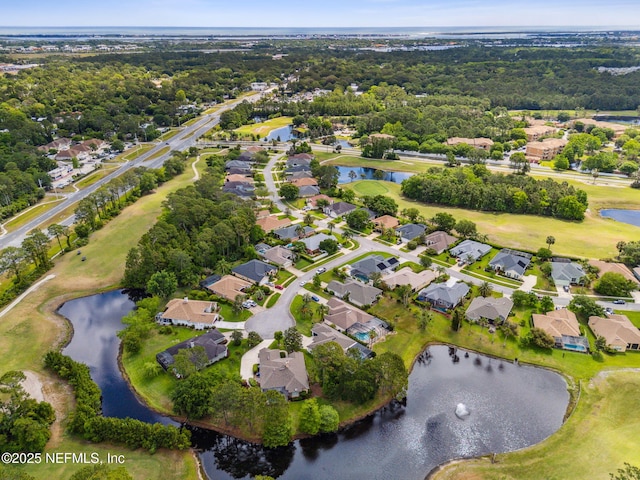 birds eye view of property with a water view and a residential view
