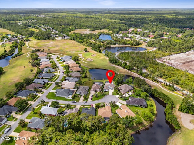 aerial view featuring a residential view, golf course view, a water view, and a wooded view