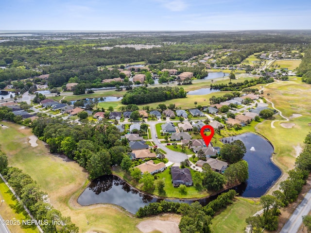 drone / aerial view featuring a water view, a residential view, and golf course view
