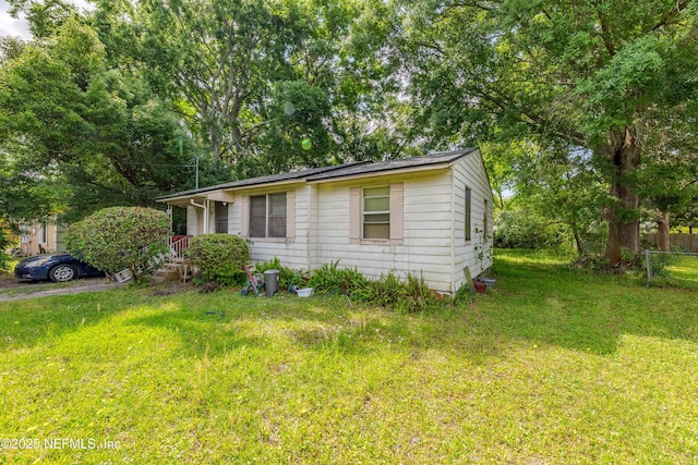 exterior space featuring fence and a yard