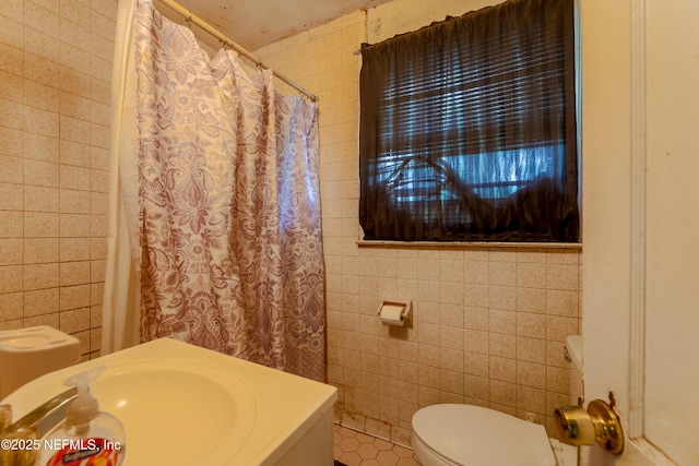 full bath featuring toilet, tile walls, tile patterned flooring, and vanity