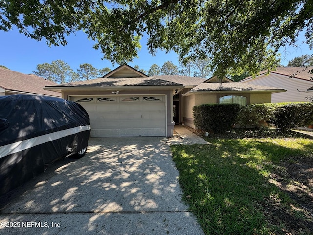 1559 Beecher Ln, Orange Park, FL 32073 - ranch-style house featuring a garage, stucco siding, and driveway