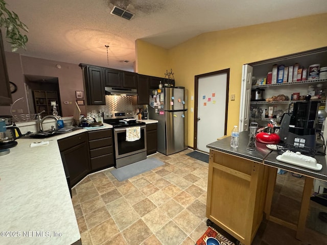 1559 Beecher Ln, Orange Park, FL 32073 - kitchen with decorative backsplash, visible vents, appliances with stainless steel finishes, light countertops, and under cabinet range hood