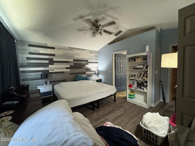 1559 Beecher Ln, Orange Park, FL 32073 - bedroom with a textured ceiling, visible vents, wood finished floors, and lofted ceiling