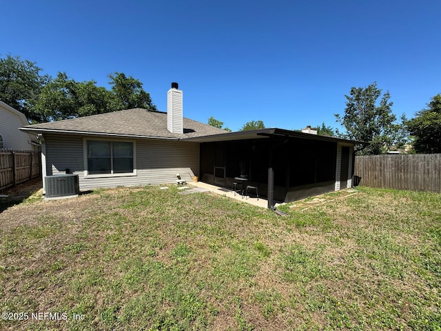 1559 Beecher Ln, Orange Park, FL 32073 - back of property featuring a sunroom, a fenced backyard, a chimney, and cooling unit