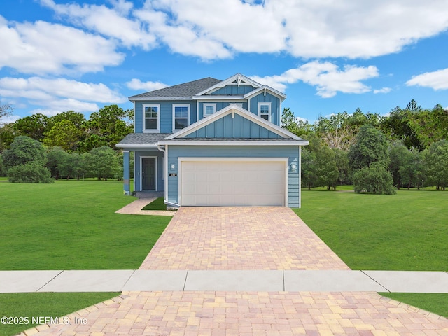 craftsman-style house featuring a garage, board and batten siding, decorative driveway, and a front yard