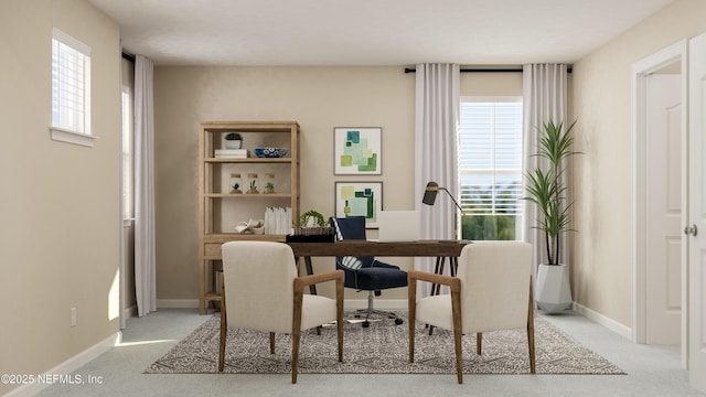 office space with light colored carpet, baseboards, and plenty of natural light