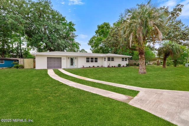 ranch-style house featuring fence, driveway, a front yard, and a garage