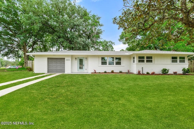 ranch-style house featuring a garage, a front lawn, fence, and driveway