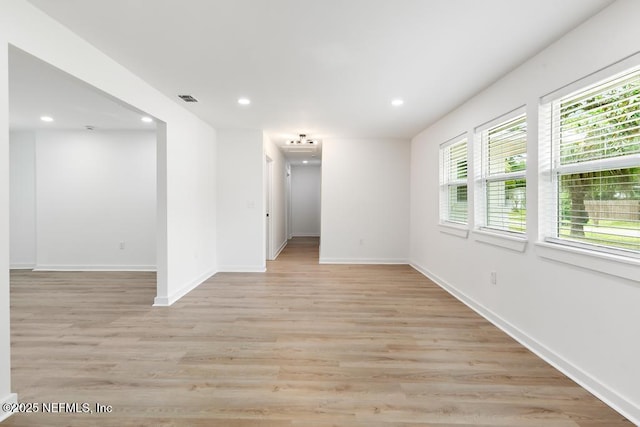 spare room with recessed lighting, baseboards, and visible vents