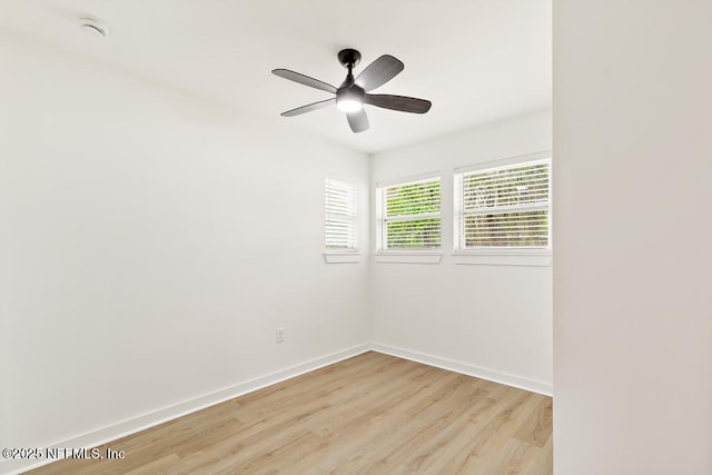 empty room with a ceiling fan, baseboards, and light wood-type flooring