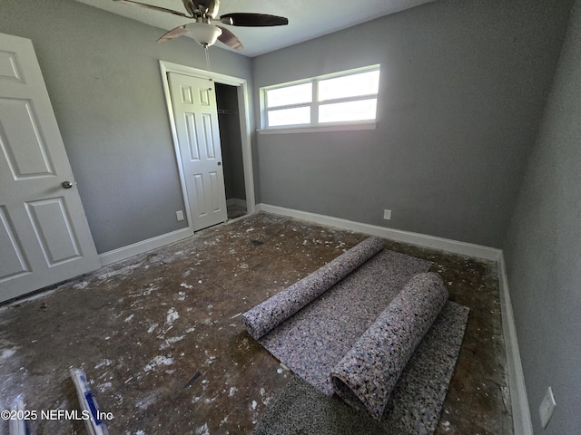 unfurnished bedroom featuring baseboards, ceiling fan, and a closet