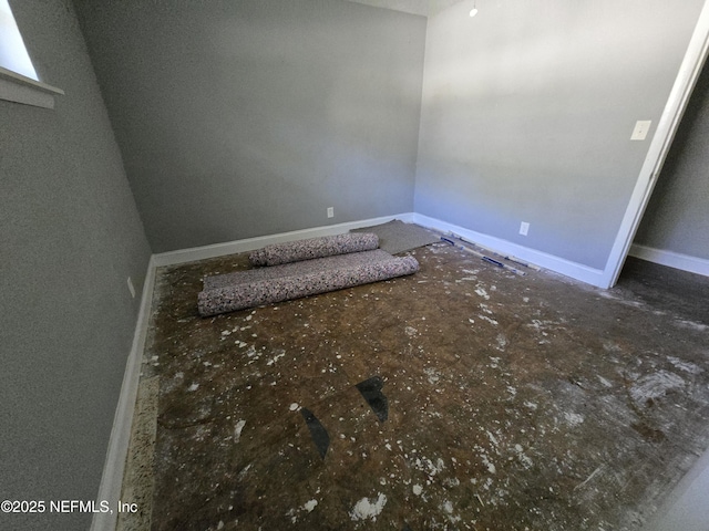 empty room featuring baseboards