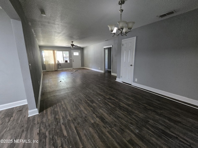 unfurnished living room with visible vents, baseboards, dark wood-style floors, a textured ceiling, and ceiling fan with notable chandelier
