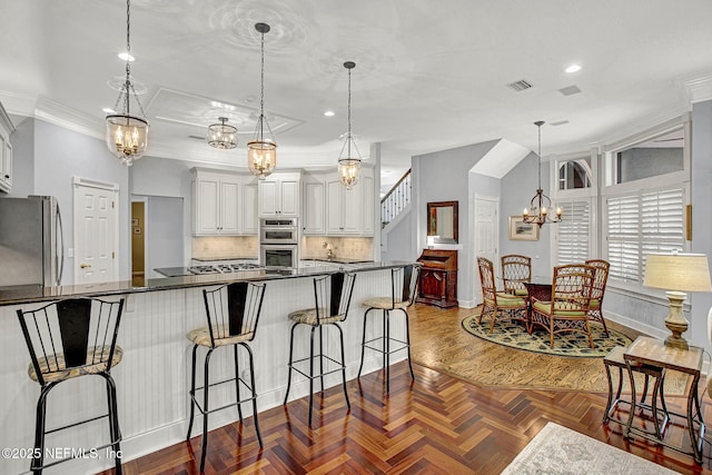 3277 Sequoyah Cir, Saint Johns, FL 32259 - kitchen with visible vents, tasteful backsplash, a notable chandelier, ornamental molding, and stainless steel appliances