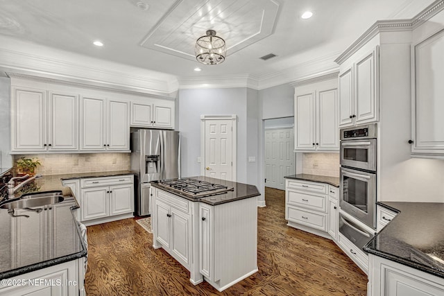 3277 Sequoyah Cir, Saint Johns, FL 32259 - kitchen with white cabinets, appliances with stainless steel finishes, a sink, dark wood finished floors, and a warming drawer