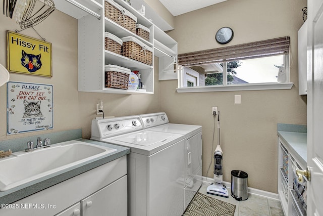 3277 Sequoyah Cir, Saint Johns, FL 32259 - clothes washing area with washing machine and dryer, baseboards, a sink, cabinet space, and light tile patterned floors