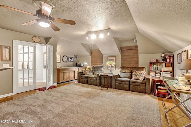 3277 Sequoyah Cir, Saint Johns, FL 32259 - interior space featuring a ceiling fan, a textured ceiling, vaulted ceiling, baseboards, and light carpet
