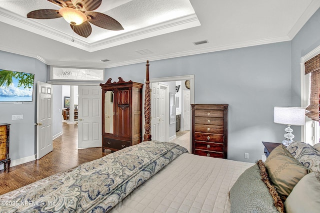 3277 Sequoyah Cir, Saint Johns, FL 32259 - bedroom with crown molding, a tray ceiling, visible vents, and wood finished floors