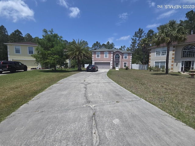 view of front of home with a garage, a front yard, and concrete driveway