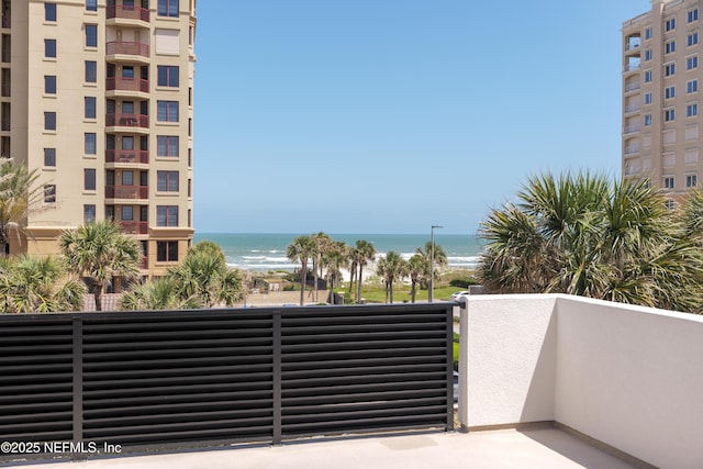 balcony with a beach view and a water view