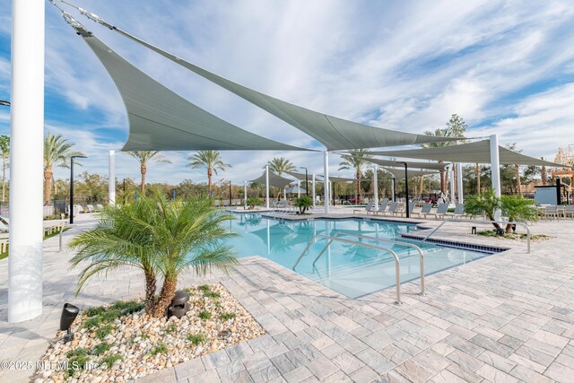 community pool with a patio area