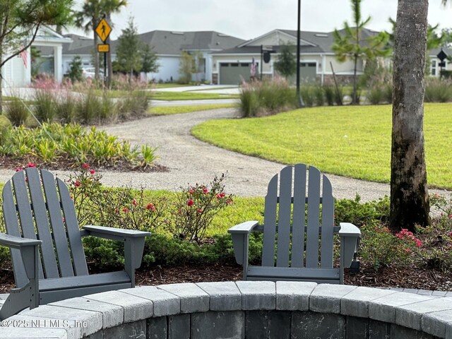 view of community featuring a lawn and a garage