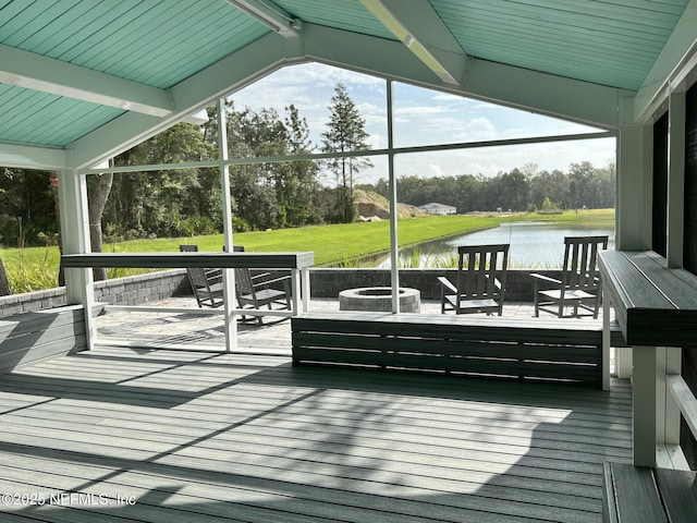 exterior space with an outdoor living space with a fire pit, a water view, and a yard