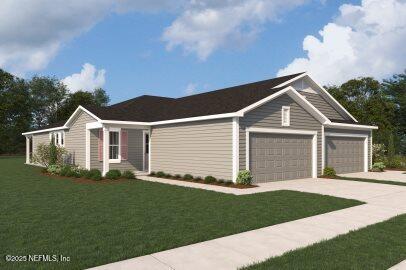 view of front of home featuring an attached garage, driveway, and a front lawn