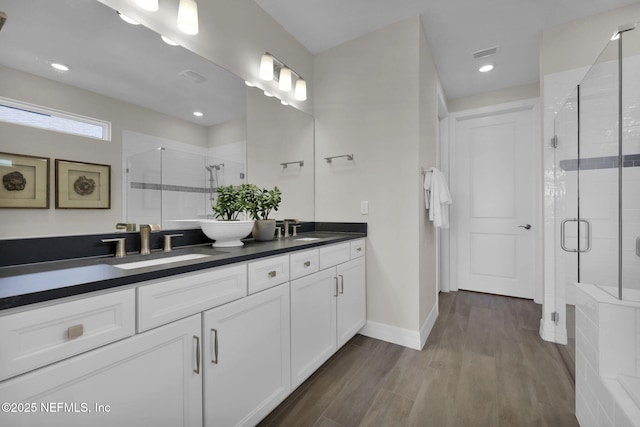 208 Curved Bay Trl, Ponte Vedra, FL 32081 - bathroom with double vanity, a shower stall, a sink, and wood finished floors