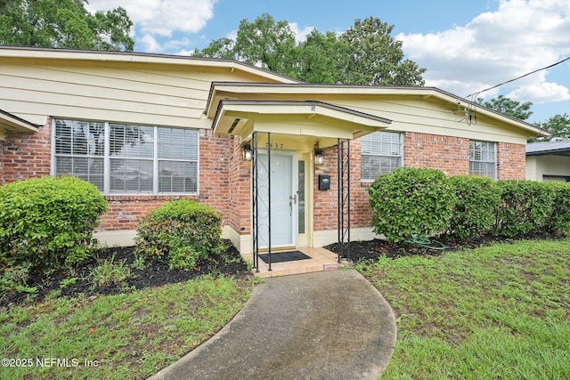 7437 Ortega Hills Dr, Jacksonville, FL 32244 - view of front of home featuring brick siding and a front lawn