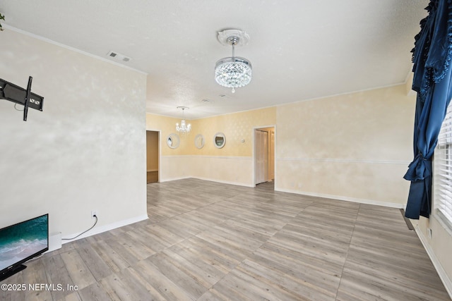 7437 Ortega Hills Dr, Jacksonville, FL 32244 - spare room featuring a chandelier, wood finished floors, a wainscoted wall, ornamental molding, and baseboards