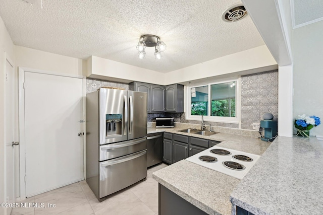 7437 Ortega Hills Dr, Jacksonville, FL 32244 - kitchen with stainless steel appliances, gray cabinetry, a sink, light countertops, and decorative backsplash