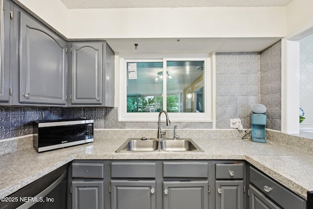 7437 Ortega Hills Dr, Jacksonville, FL 32244 - kitchen with gray cabinetry, a sink, backsplash, light countertops, and dishwasher