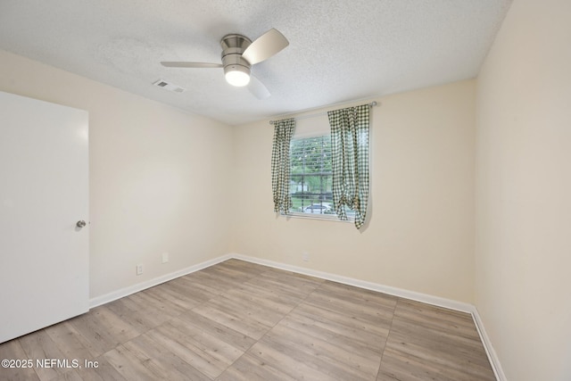 7437 Ortega Hills Dr, Jacksonville, FL 32244 - spare room with a textured ceiling, wood finished floors, a ceiling fan, and baseboards