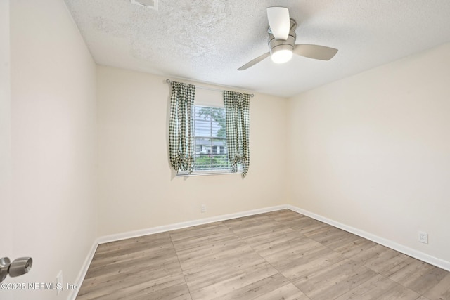 7437 Ortega Hills Dr, Jacksonville, FL 32244 - empty room with a textured ceiling, ceiling fan, baseboards, and wood finished floors