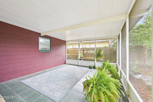 7437 Ortega Hills Dr, Jacksonville, FL 32244 - unfurnished sunroom featuring beam ceiling