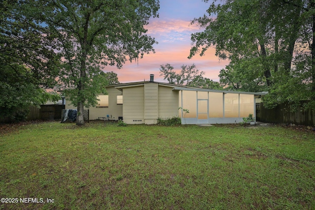 7437 Ortega Hills Dr, Jacksonville, FL 32244 - back of house at dusk featuring a sunroom