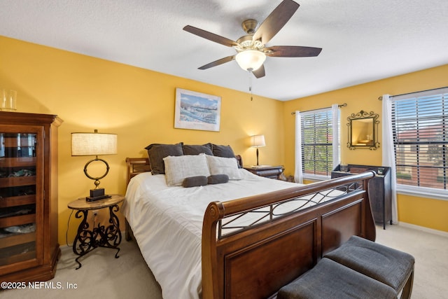 bedroom featuring baseboards, a ceiling fan, and light carpet