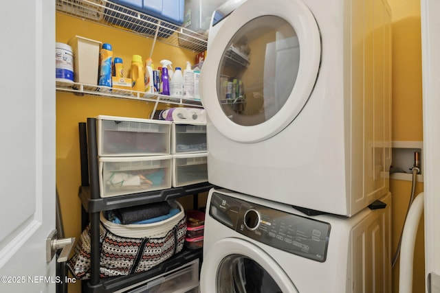 laundry area with stacked washer and dryer and laundry area