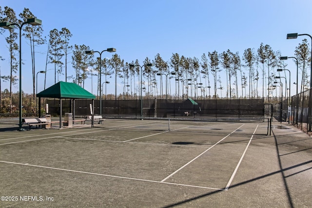 view of sport court featuring fence